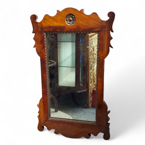 36 - A George II Revival walnut Vauxhall mirror, parcel gilt Tudor rose motif, planked back, 75cm high