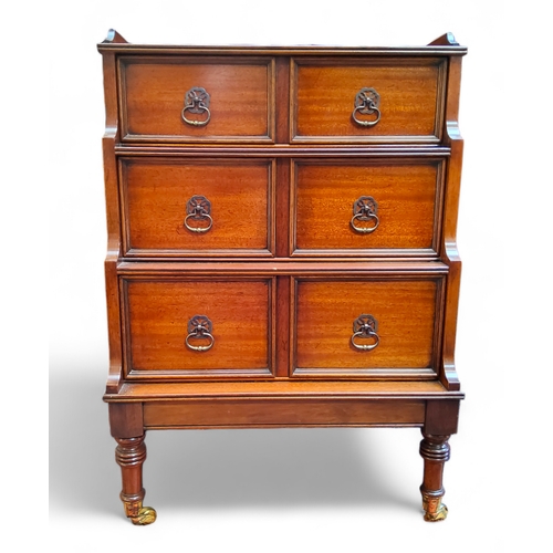 61 - A 20th century campaign style walnut waterfall chest of drawers, gallery top above three fielded pan... 