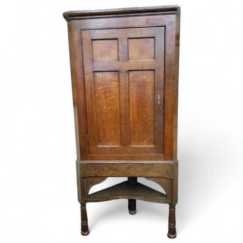 112 - A George III English oak country house corner cupboard on stand c.1780