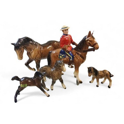 418 - A Japanese model, Canadian Mountie Policeman on bay horse, gloss, , 20.5cm high, model no 8080,... 