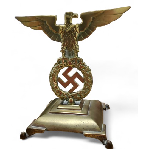 162 - A WWII German Third Reich car mascot or desk ornament mounted on a bell metal base, cast with an eag... 