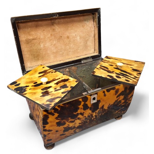 335 - An early Victorian tortoiseshell bowed rectangular tea caddy, hinged pagoda top, two lidded compartm... 