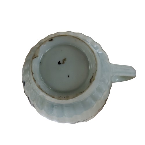A Lowestoft fluted coffee cup, in underglaze blue with floral sprays ...