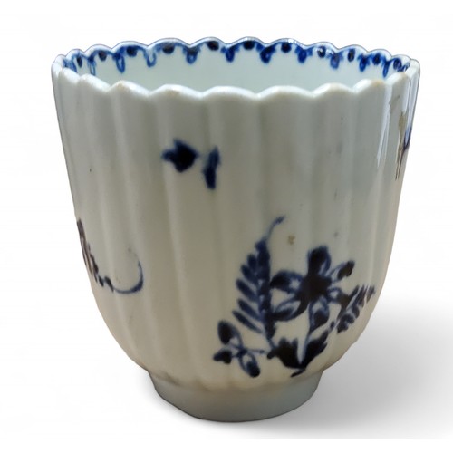 A Lowestoft fluted coffee cup, in underglaze blue with floral sprays ...