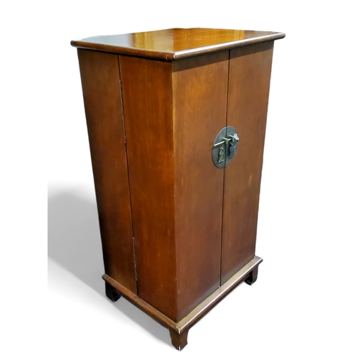 637 - A  mahogany cabinet, in in the Oriental manner, circular lock plate, opening to reveal multiple... 