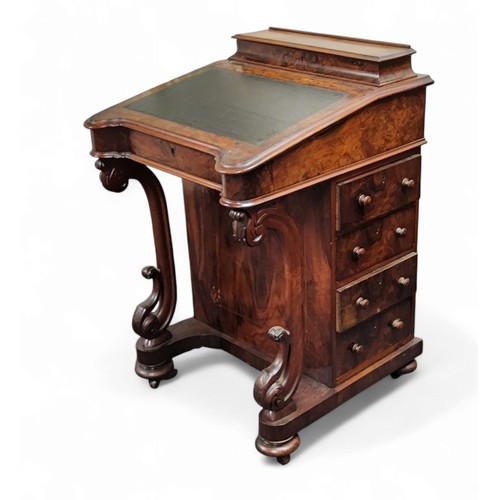 631 - A Victorian walnut Davenport desk, hinged superstructure enclosing stationery divisions, the hinged ... 