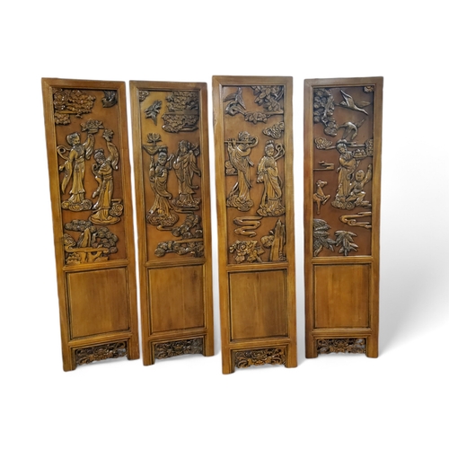 465 - Four Chinese carved camphor wood modesty screen panels, decorated in relief with Guanyin and other i... 