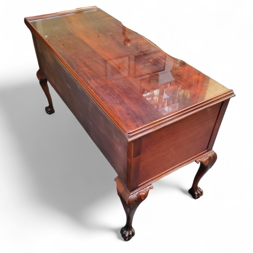 472 - A Chippendale Revival flamed mahogany dressing table, dished top holding protective glass top, one l... 