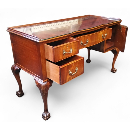 472 - A Chippendale Revival flamed mahogany dressing table, dished top holding protective glass top, one l... 