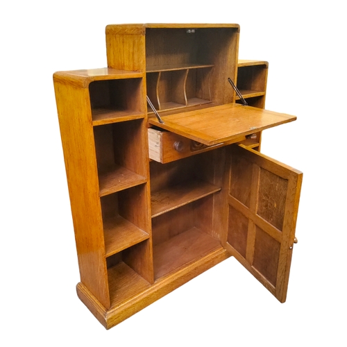 520 - An Art Deco golden oak student's bureau, the fall front carved with Celtic design revealing pigeon h... 