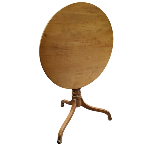 386 - An early 19th century bleached elm circular tilt top farmhouse table, turned support, cabriole legs,... 