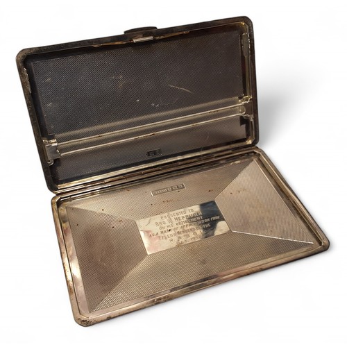 163 - A silver rectangular cigarette case, engine turned decoration, engraved presentation to inside cover... 