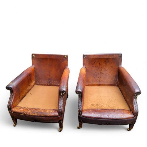 400 - An early 20th century studded leather three piece suite, including a pair of club chairs (for restor... 