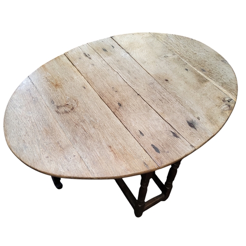 404 - A small late 18th century English oak oval drop leaf gateleg tavern table, stripped top over period ... 