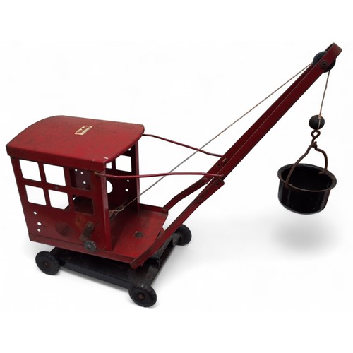 723A - A Triang No.2 tinplate crane, complete with metal hook and bucket, red, black ribbed wheels