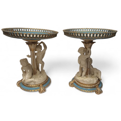 81 - A pair of mid 19th century Minton figural comports, the pierced circular dishes, banded in turquoise... 