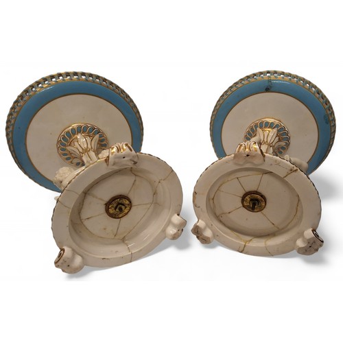 81 - A pair of mid 19th century Minton figural comports, the pierced circular dishes, banded in turquoise... 