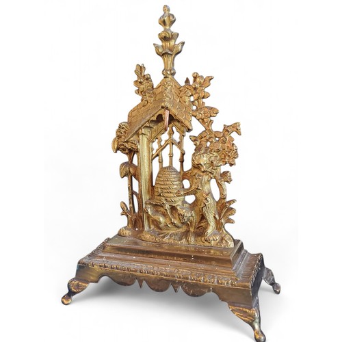 301 - A 19th century gilt metal pocket watch stand, cast and pierced with bears at a bee hive, rectangular... 