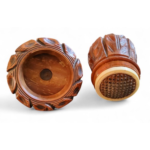 293 - A 19th century coquilla nut nutmeg grater, carved with stiff leaves, 7.5cm high, c.1860