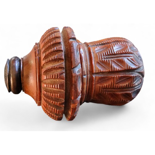 293 - A 19th century coquilla nut nutmeg grater, carved with stiff leaves, 7.5cm high, c.1860