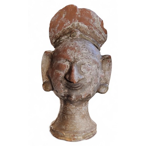 467 - Antiquities - a terracotta head, Indian, 24cm high