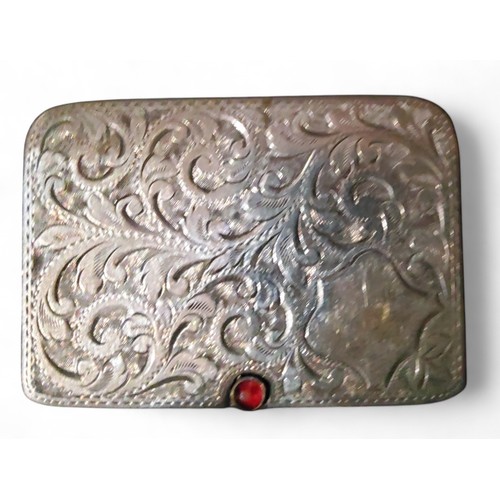 15 - An Edwardian silver rounded rectangular double stamp case, the sliding cover engraved and chased wit... 