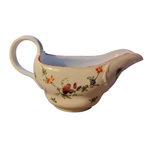 82 - A Bristol sauceboat, painted with floral swags, moulded scroll borders, brown line rim, 17cm wide, c... 