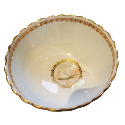 84 - A Caughley tea bowl and saucer, painted with L’AMITIE within a gilt foliate border, c.1790