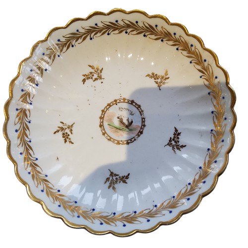 84 - A Caughley tea bowl and saucer, painted with L’AMITIE within a gilt foliate border, c.1790