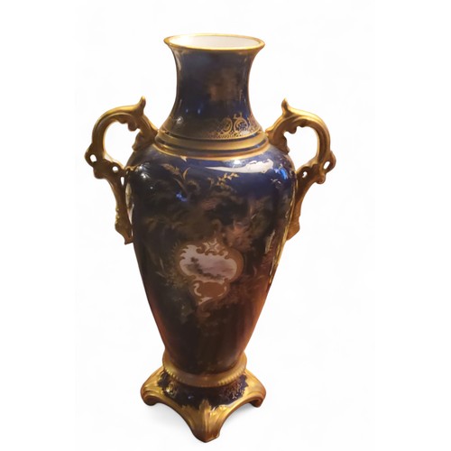 87 - A Coalport two handled ovoid vase and cover,  painted with a landscape within a gilt scroll cartouch... 