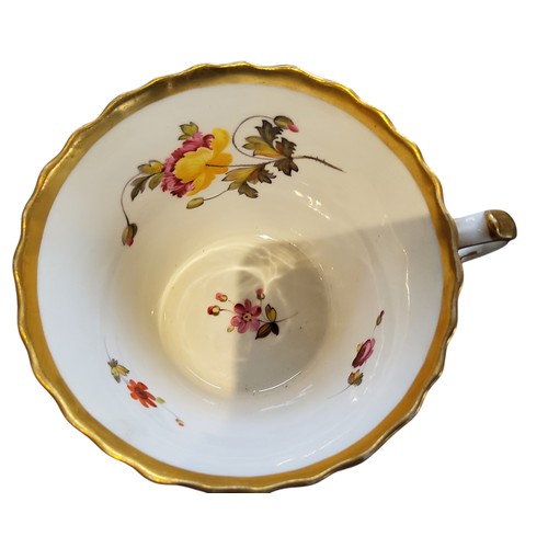 145 - A Chamberlains coffee cup and saucer, painted with flowers on an intricate gilt ground, printed lion... 