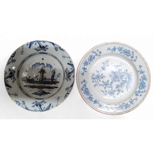 90 - An English Delft charger, painted in blue in the chinoiserie manner, with figure and willow tree, th... 