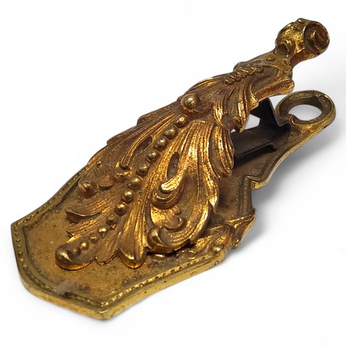 448 - An early 20th century French gilt metal desk weight paperclip, 12cm long, c.1900