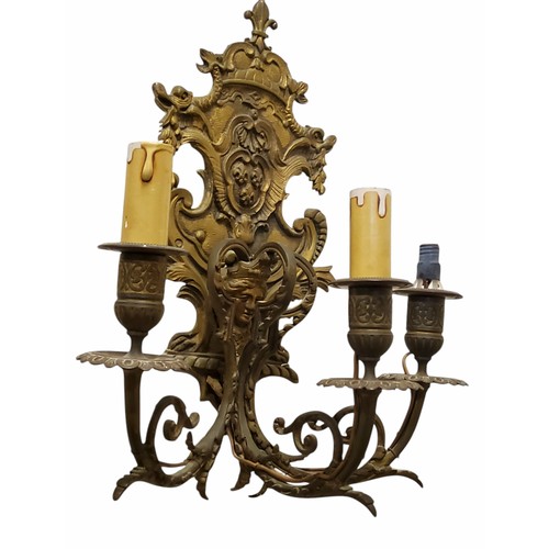 367 - A pair of Renaissance style Continental gilt metal three branch wall sconces, cartouche shaped backp... 