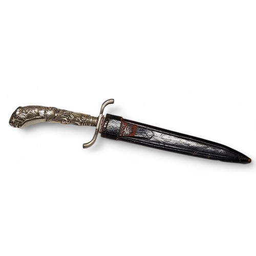 289 - A 19th century Continental white metal mounted hunting dagger, terminating with a pouncing lioness m... 