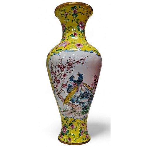 233 - A Qing dynasty Canton enamel baluster shaped vase, yellow ground, decorated with two panels depictin... 