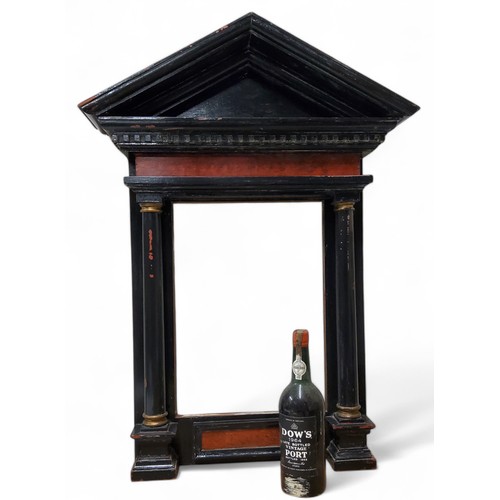 675 - A Grand Tour aedicular, or tabernacle ebonised frame, Doric column supports, inner measurements 47cm... 