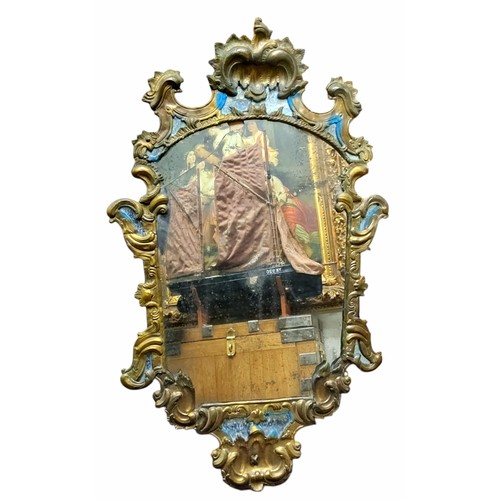 636 - A Continental carved giltwood and pressed metal adorned mirror, 100cm x 56cm (faults to foxed lookin... 