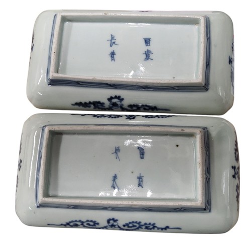 238 - A pair of Japanese rounded rectangular dishes, painted in underglazed blue with stylised lilies, dee... 