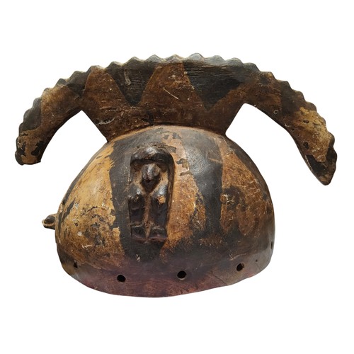 598 - Tribal Art - a Mossi helmet mask, decorated with abstract motifs in yellow, black and  brown earth p... 