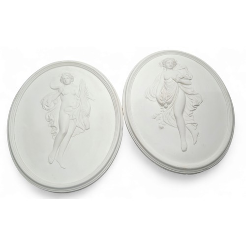 683 - A large pair of oval plaster plaques, in relief with classical figures, 43cm x 34cm