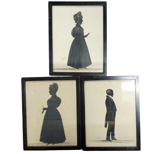 486 - English School, 19th century, a pair of  silhouettes, a gentleman and his wife, picked out in gilt, ... 