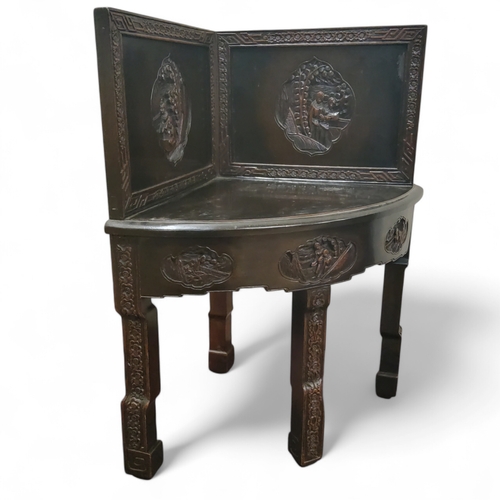 244 - Oriental Furniture - an early 20th century Chinese Export carved corner chair, black lacquered finis... 