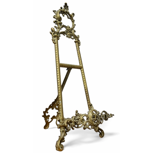 681 - A large 20th century Roccoco brass easel, pierced with foliate scrolls, 54cm x 26cm x 26cm