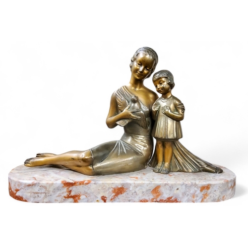 522 - French School, Art Deco,  after H Balleste, a parcel gilt bronze, of a seated lady holding a swallow... 