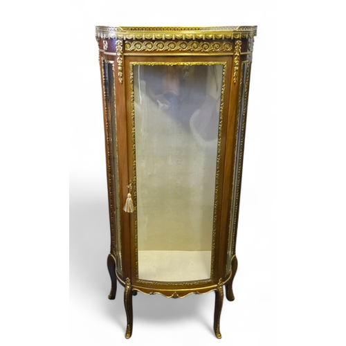 660 - A French Louis XVI style vitrine, 20th century, of D-shape, the top with pierced gallery and marble ... 