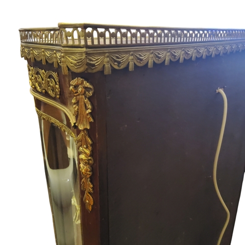 660 - A French Louis XVI style vitrine, 20th century, of D-shape, the top with pierced gallery and marble ... 