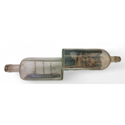 344 - A late 19th/early 20th ship in a bottle, the three masts, 30cm high;  another, 23.5cm (2)