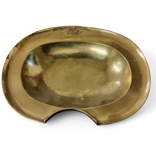 662 - A George III barber's brass shaving/bleeding bowl, of oval form, plain rim, filled hanging piercing,... 