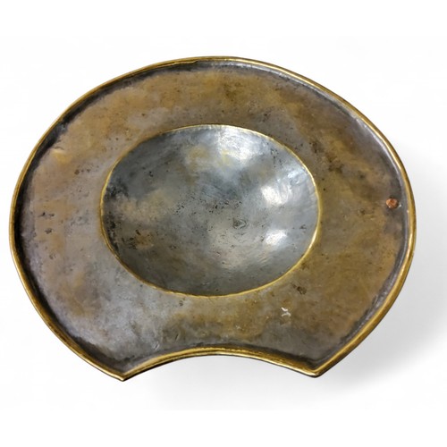 663 - A George III barber's brass shaving/bleeding bowl, of oval form, rolled rim, 21cm wide, c.1815